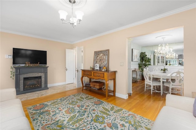 25 Rosewood Dr, North Providence, RI 02904 - living area with a chandelier, crown molding, wood finished floors, and a glass covered fireplace