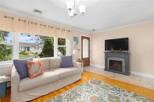 25 Rosewood Dr, North Providence, RI 02904 - living room featuring a chandelier, ornamental molding, a glass covered fireplace, and wood finished floors