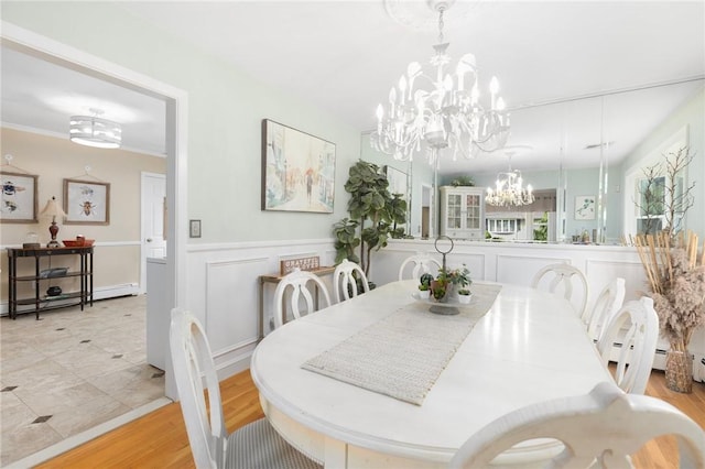 25 Rosewood Dr, North Providence, RI 02904 - dining area featuring a chandelier, a wainscoted wall, light wood finished floors, and a baseboard heating unit