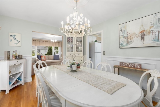 25 Rosewood Dr, North Providence, RI 02904 - dining room featuring a chandelier, light wood-style flooring, and wainscoting