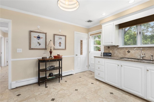 25 Rosewood Dr, North Providence, RI 02904 - kitchen featuring a baseboard radiator, ornamental molding, white cabinetry, dark stone countertops, and decorative backsplash