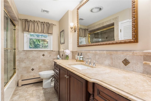 25 Rosewood Dr, North Providence, RI 02904 - full bath with a baseboard radiator, vanity, tile walls, bath / shower combo with glass door, and a wainscoted wall
