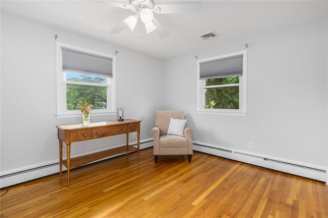 25 Rosewood Dr, North Providence, RI 02904 - living area with a baseboard radiator, light wood-style floors, and ceiling fan
