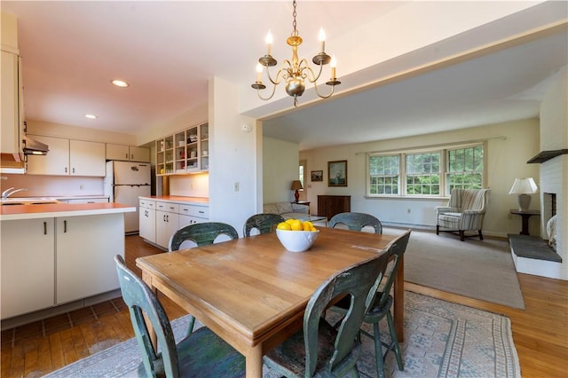 61 Bay View Rd, Charlestown, RI 02813 - dining area with a chandelier, wood finished floors, and recessed lighting