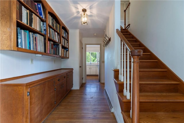 61 Bay View Rd, Charlestown, RI 02813 - corridor featuring hardwood / wood-style flooring, a baseboard heating unit, and stairs