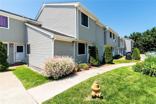 66 Girard Ave Unit 322, Newport, RI 02840 - view of home's exterior featuring a lawn and entry steps