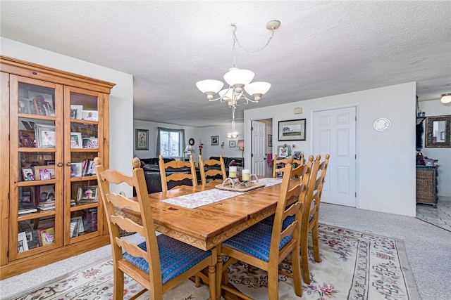 66 Girard Ave Unit 322, Newport, RI 02840 - dining space with a chandelier, light colored carpet, and a textured ceiling