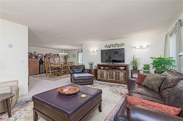 66 Girard Ave Unit 322, Newport, RI 02840 - living area featuring a textured ceiling and a chandelier