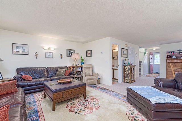 66 Girard Ave Unit 322, Newport, RI 02840 - carpeted living area featuring a textured ceiling and stairway