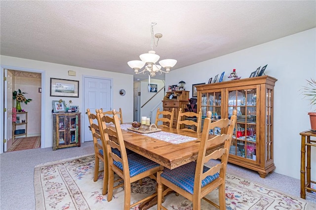 66 Girard Ave Unit 322, Newport, RI 02840 - dining room featuring a chandelier, light carpet, and a textured ceiling