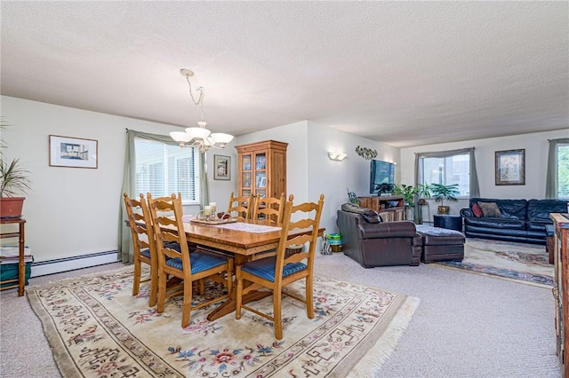 66 Girard Ave Unit 322, Newport, RI 02840 - dining room with baseboard heating, a chandelier, light carpet, and a textured ceiling
