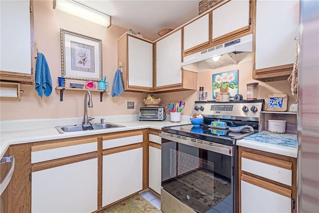 66 Girard Ave Unit 322, Newport, RI 02840 - kitchen with stainless steel range with electric cooktop, under cabinet range hood, light countertops, and white cabinets