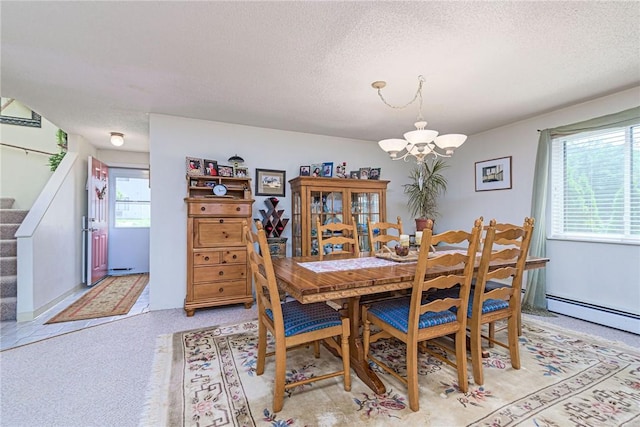 66 Girard Ave Unit 322, Newport, RI 02840 - dining room with a chandelier, stairway, a textured ceiling, a baseboard heating unit, and light colored carpet