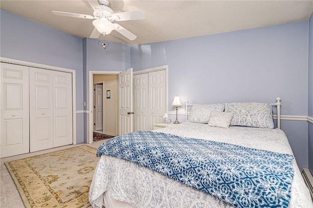 66 Girard Ave Unit 322, Newport, RI 02840 - bedroom with two closets, carpet, a ceiling fan, and a baseboard heating unit