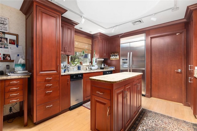 6 Lachance Ave, Warwick, RI 02889 - kitchen featuring built in refrigerator, rail lighting, light wood-type flooring, light stone countertops, and wallpapered walls