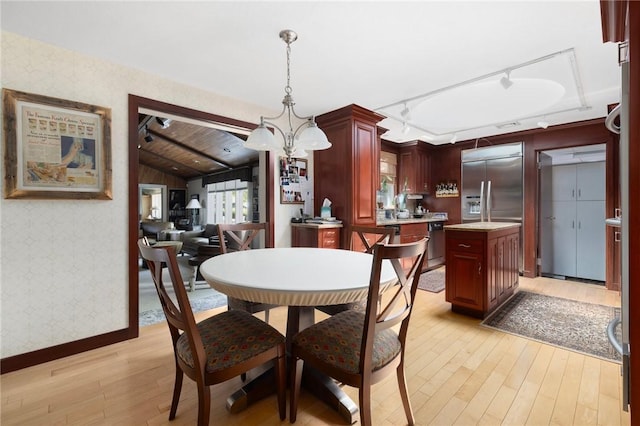 6 Lachance Ave, Warwick, RI 02889 - dining area with wallpapered walls, light wood-type flooring, rail lighting, and vaulted ceiling
