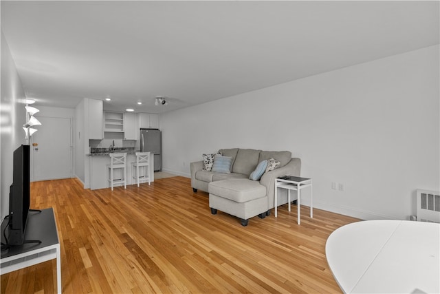 401 Bellevue Ave Unit 214, Newport, RI 02840 - living room with light wood finished floors, recessed lighting, and radiator