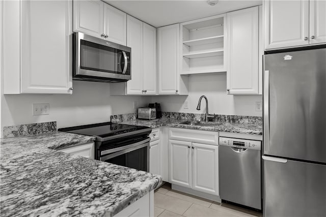 401 Bellevue Ave Unit 214, Newport, RI 02840 - kitchen featuring appliances with stainless steel finishes, open shelves, white cabinets, and stone countertops