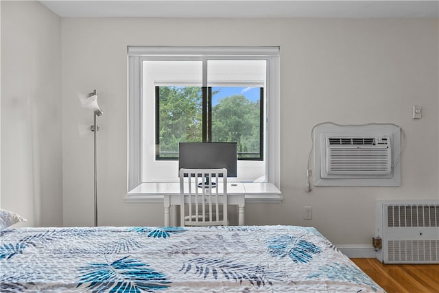 401 Bellevue Ave Unit 214, Newport, RI 02840 - bedroom featuring wood finished floors, an AC wall unit, and heating unit