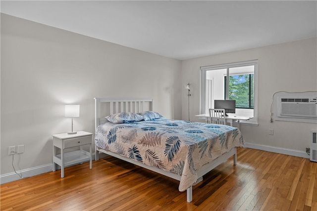 401 Bellevue Ave Unit 214, Newport, RI 02840 - bedroom with a wall unit AC and light wood-style flooring
