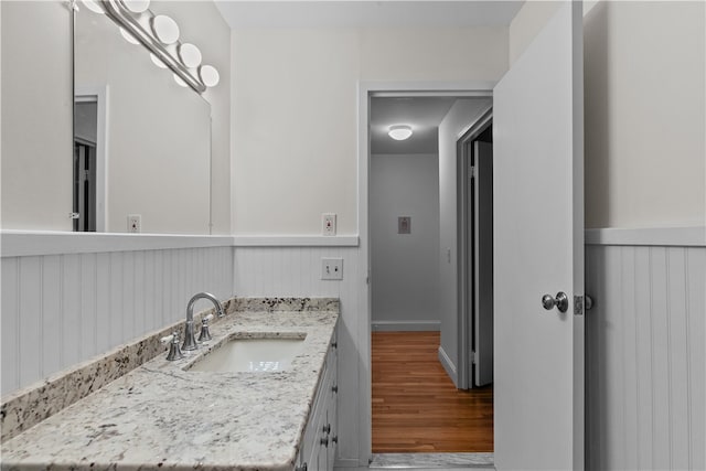 401 Bellevue Ave Unit 214, Newport, RI 02840 - bathroom with wood finished floors, vanity, and wainscoting