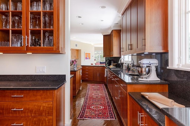 1003 Fort Getty Rd, Jamestown, RI 02835 - kitchen featuring dark wood finished floors, dark stone countertops, brown cabinets, backsplash, and recessed lighting