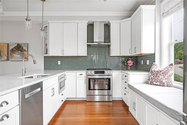 100 Algonquin Rd Unit 5, Narragansett, RI 02882 - kitchen with stainless steel appliances, wall chimney range hood, crown molding, light countertops, and white cabinetry