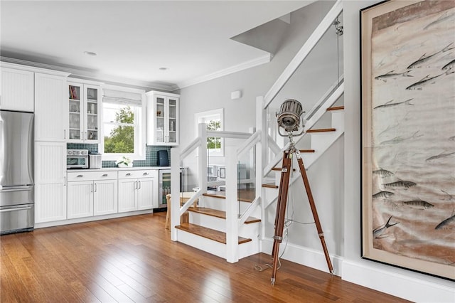 100 Algonquin Rd Unit 5, Narragansett, RI 02882 - stairs featuring beverage cooler, ornamental molding, and wood finished floors
