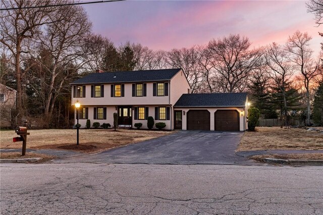 10 Eastgate Dr, Coventry, RI 02816 - colonial-style house featuring an attached garage and asphalt driveway