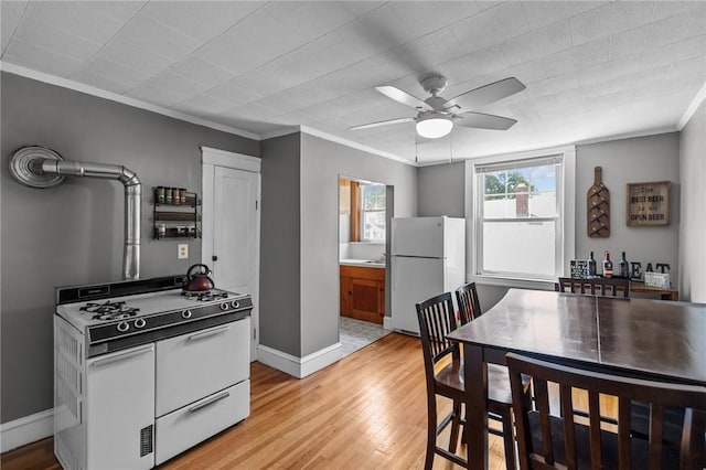 39 Owen Ave, Pawtucket, RI 02860 - kitchen with white appliances, crown molding, light wood-type flooring, a ceiling fan, and brown cabinets