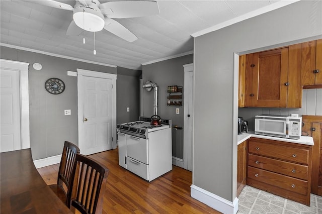 39 Owen Ave, Pawtucket, RI 02860 - kitchen featuring white appliances, brown cabinetry, a ceiling fan, ornamental molding, and light wood-style floors