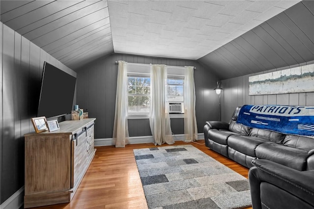 39 Owen Ave, Pawtucket, RI 02860 - living area featuring vaulted ceiling, light wood-style flooring, cooling unit, and wooden walls