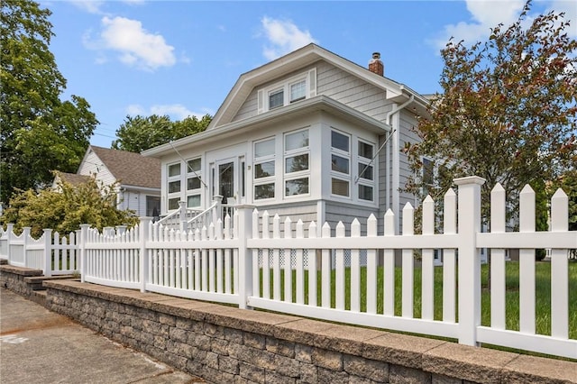 39 Owen Ave, Pawtucket, RI 02860 - view of front facade with a chimney and a fenced front yard