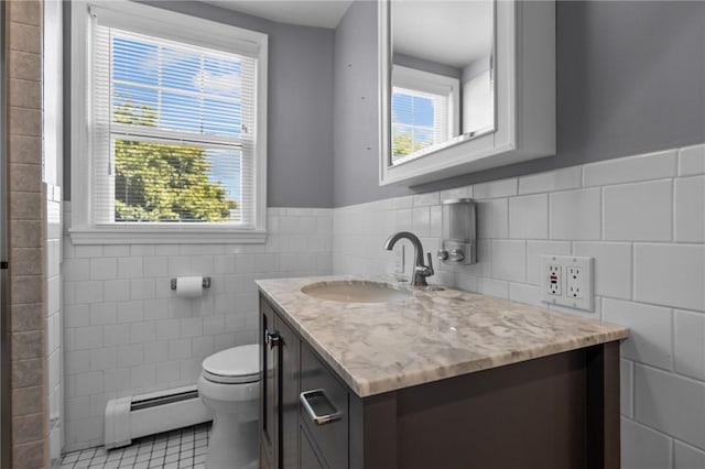 39 Owen Ave, Pawtucket, RI 02860 - bathroom featuring a baseboard radiator, tile walls, vanity, tile patterned flooring, and wainscoting