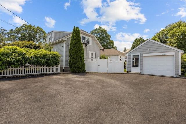 39 Owen Ave, Pawtucket, RI 02860 - view of side of home with a gate, a garage, driveway, and an outbuilding