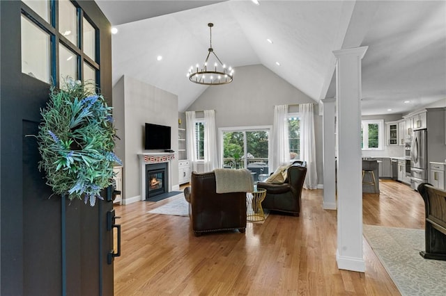 52 Pine Swamp Rd, Cumberland, RI 02864 - living room featuring high vaulted ceiling, a glass covered fireplace, light wood-type flooring, a chandelier, and recessed lighting