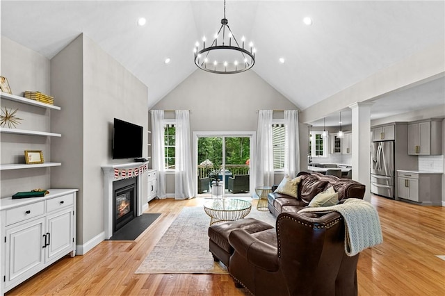 52 Pine Swamp Rd, Cumberland, RI 02864 - living room featuring high vaulted ceiling, a chandelier, a fireplace with flush hearth, light wood-style floors, and recessed lighting