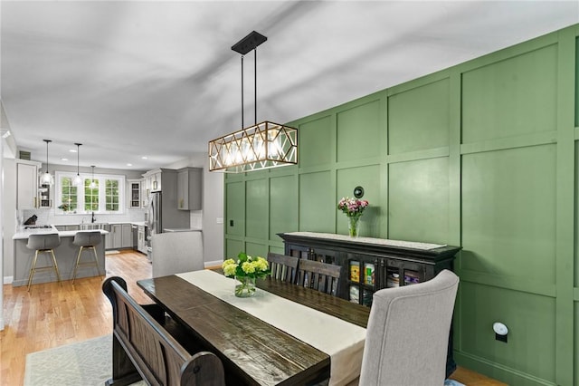 52 Pine Swamp Rd, Cumberland, RI 02864 - dining room with a chandelier, light wood-type flooring, recessed lighting, and a decorative wall