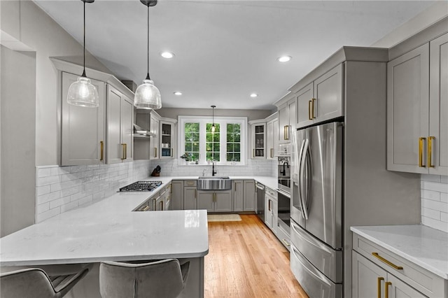 52 Pine Swamp Rd, Cumberland, RI 02864 - kitchen with appliances with stainless steel finishes, gray cabinets, a peninsula, tasteful backsplash, and recessed lighting