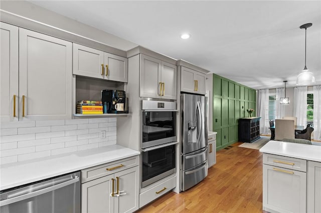 52 Pine Swamp Rd, Cumberland, RI 02864 - kitchen featuring appliances with stainless steel finishes, tasteful backsplash, light countertops, light wood-style floors, and recessed lighting