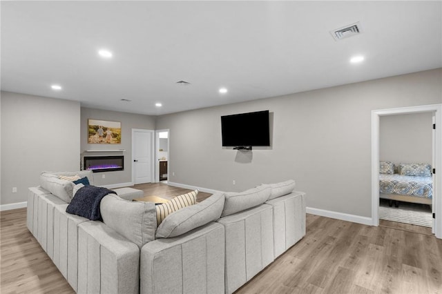 52 Pine Swamp Rd, Cumberland, RI 02864 - living room featuring recessed lighting, light wood-style floors, and a glass covered fireplace