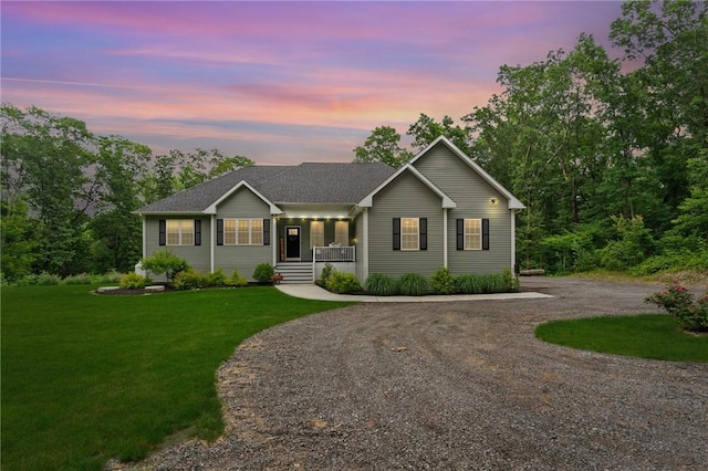 52 Pine Swamp Rd, Cumberland, RI 02864 - ranch-style home featuring a porch, curved driveway, and a lawn