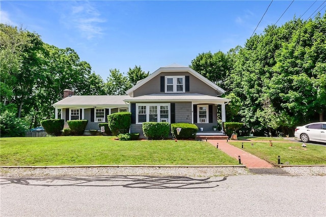 11 Crossland Rd, West Warwick, RI 02893 - view of front facade with a front yard, a porch, and a chimney