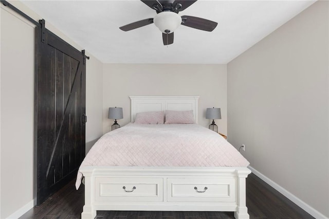 111 Bramble Bush Rd, Coventry, RI 02816 - bedroom featuring a barn door, dark wood-style floors, and a ceiling fan