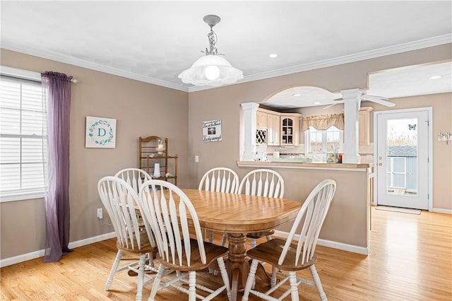 16 Elm Ave, Narragansett, RI 02882 - dining room with decorative columns, light wood-style floors, ornamental molding, and arched walkways