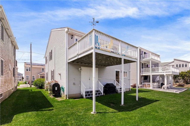 16 Elm Ave, Narragansett, RI 02882 - rear view of property featuring entry steps, a wooden deck, a lawn, and a patio
