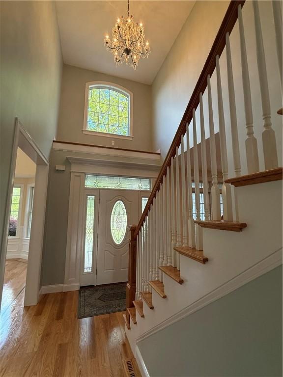115 Read St, Attleboro, MA 02703 - foyer featuring a high ceiling, wood finished floors, a chandelier, and stairs