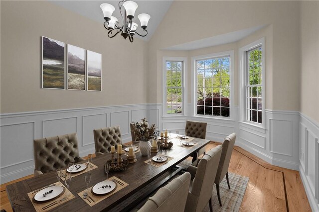 115 Read St, Attleboro, MA 02703 - dining space with a chandelier, a wainscoted wall, light wood-style floors, a decorative wall, and vaulted ceiling
