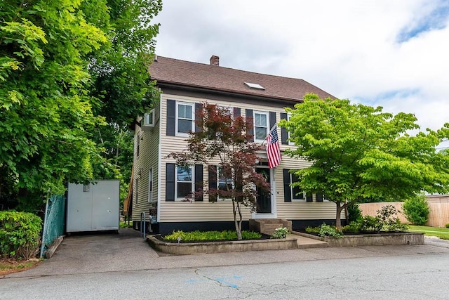 15 N St, Warwick, RI 02886 - colonial house featuring a chimney, an outbuilding, and entry steps