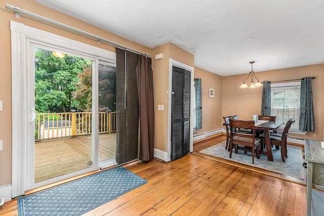 15 N St, Warwick, RI 02886 - dining area featuring light wood-type flooring, a chandelier, and a baseboard heating unit